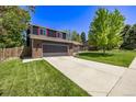 Attractive two-story home showcasing a well-manicured lawn and a spacious driveway leading to a two-car garage at 6062 S Newport St, Centennial, CO 80111