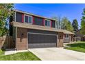 Home featuring a spacious two-car garage with a paved driveway and freshly cut green grass at 6062 S Newport St, Centennial, CO 80111