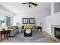 Bright living room with vaulted ceiling features comfortable seating, a fireplace, and large windows for natural light at 5238 S Jericho Way, Centennial, CO 80015