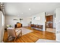 Bright living room featuring hardwood floors, stylish decor and furniture with a view to the kitchen at 9325 Meade St, Westminster, CO 80031