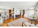 Open-concept living space with hardwood floors and seamless transition into the dining and kitchen areas at 9325 Meade St, Westminster, CO 80031