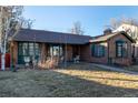 Ranch home with brick exterior and green accents at 1475 Monaco Pkwy, Denver, CO 80220