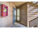 This inviting entryway boasts a secure door, and warm neutral toned wooden walls with a visible staircase nearby at 12368 W Nevada Pl # 206, Lakewood, CO 80228