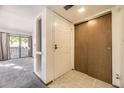 Bright entryway features tile floors, a closet, and opens to a living area with sliding glass doors and a balcony at 12368 W Nevada Pl # 206, Lakewood, CO 80228