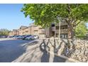 Well maintained condo complex boasts convenient parking and beautiful landscaping, set against a clear blue sky at 12368 W Nevada Pl # 206, Lakewood, CO 80228