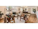 Bright living room with hardwood floors, stylish furnishings, and a large window providing ample natural light at 9455 W 37Th Ave, Wheat Ridge, CO 80033