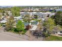 Aerial view of the house showing its layout, driveway, surrounding neighborhood, and landscaping at 6245 W 53Rd Ave, Arvada, CO 80002