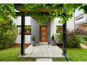 Stylish home entryway featuring a modern door, decorative planters, and a covered porch at 3727 Tejon St, Denver, CO 80211
