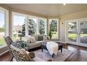 Bright sunroom features hardwood floors and ample natural light at 17575 E Kettle Pl, Centennial, CO 80016