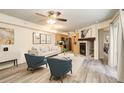 Open living area features a decorative fireplace, ceiling fan, and modern decor at 1820 Newland Ct # 213, Lakewood, CO 80214