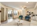 Cozy living room featuring a ceiling fan, desk area, neutral walls, and sliding glass doors to the outside at 1820 Newland Ct # 213, Lakewood, CO 80214