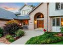 Inviting home entrance with well-maintained landscaping and a cozy bench, perfect for enjoying the outdoors at 2245 Ridgeview Way, Longmont, CO 80504