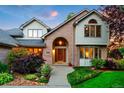 Beautiful front exterior with brick accents, lush landscaping, and an arched entryway for added charm at 2245 Ridgeview Way, Longmont, CO 80504