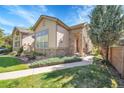 Inviting home exterior with stone accents, mature landscaping, and a welcoming entryway at 14333 E Napa Pl # 5D, Aurora, CO 80014