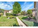 Beautifully landscaped front yard with mature trees and a well-manicured lawn at 14333 E Napa Pl # 5D, Aurora, CO 80014