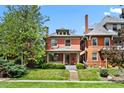 Charming home with a well-maintained lawn and inviting curb appeal at 1545 Steele St, Denver, CO 80206