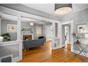 Open living area boasts hardwood floors, a fireplace, and elegant architectural details at 1545 Steele St, Denver, CO 80206