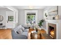 Bright living room features hardwood floors, a cozy fireplace, and large windows at 1545 Steele St, Denver, CO 80206