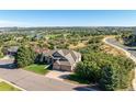 A high angle shows a single-story home with mature landscaping and mountain views at 228 Emerald Ct, Castle Rock, CO 80104