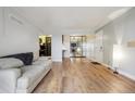 Open concept living room with wood flooring, neutral walls, and modern decor at 579 Wright St # 204, Lakewood, CO 80228