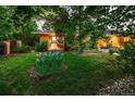 Landscaped front yard with flowers, lush greenery, and a charming facade at 250 S Dahlia St, Denver, CO 80246