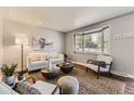 Bright and airy living room featuring modern furniture, stylish decor, and a bay window with plenty of natural light at 8258 Cherokee St, Denver, CO 80221