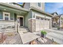 Inviting front entrance with stone accents, a two-car garage, and a well-manicured walkway at 1066 S Eaton Park Ct, Aurora, CO 80018