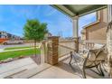 Cozy front porch featuring comfortable seating, stone accents, and a view of the neighborhood at 1066 S Eaton Park Ct, Aurora, CO 80018