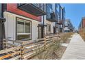 Contemporary townhouse exterior featuring metal balconies, modern design, and a welcoming entrance at 5530 W 11Th Pl, Lakewood, CO 80214