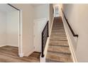 Carpeted staircase with modern railing leads to upper levels of this well-lit home at 5530 W 11Th Pl, Lakewood, CO 80214