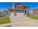 Two-story house with gray siding, red shutters, and a three-car garage at 3274 Belleville Ridge Rd, Elizabeth, CO 80107