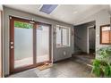 Bright entryway featuring tile floors, frosted glass door, and stairs leading to the upper level at 6303 W Exposition Ave, Lakewood, CO 80226