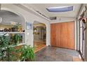 Inviting entryway with tile flooring, coat closet, archways, and views into the adjacent living spaces at 6303 W Exposition Ave, Lakewood, CO 80226