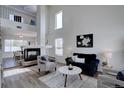 Bright living room featuring a cozy fireplace, high ceilings, and elegant decor at 18997 E 51St Pl, Denver, CO 80249