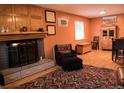 Inviting living room featuring a cozy fireplace and comfortable seating arrangement at 6213 Gray St, Arvada, CO 80003