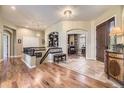 Spacious foyer featuring hardwood floors, staircase, and a view into the living room creates an inviting entry at 11070 Meade Ct, Westminster, CO 80031
