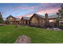 Beautiful house with stone and stucco exterior, set on a manicured lawn at 28800 Stonecrop Trl, Conifer, CO 80433