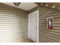 Private entrance with a security door and fire extinguisher box at 910 S Walden St # 106, Aurora, CO 80017
