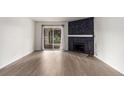 Living room features a black stone fireplace and sliding glass doors at 910 S Walden St # 106, Aurora, CO 80017