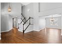 Bright and airy living room featuring hardwood floors, a staircase, and an open layout at 4695 Bobolink Dr, Castle Rock, CO 80109