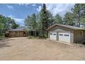 This charming home features a detached two-car garage and a serene wooded setting, offering peace and privacy at 28858 Richmond Hill Rd, Conifer, CO 80433