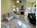 Bright living room featuring tile floors, neutral paint, fireplace, and plenty of natural light at 363 Wadsworth Cir, Longmont, CO 80504