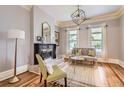 Cozy living room featuring a fireplace, hardwood floors, and ample natural light from large windows at 347 Bannock St, Denver, CO 80223