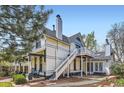 Rear exterior showcasing a two-story house with a deck and staircase to the backyard at 347 Bannock St, Denver, CO 80223