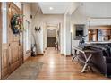 Inviting foyer featuring hardwood floors, an arched doorway, and views into the living room at 5261 Sedona Dr, Parker, CO 80134