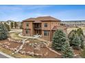 Charming two-story home with a spacious front yard, stone pathway, and mature trees at 5261 Sedona Dr, Parker, CO 80134