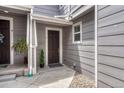 Charming entryway with a dark brown door and tasteful landscaping at 17225 Lark Water Ln # C, Parker, CO 80134