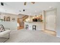 Open living area with carpeting, breakfast bar and staircase at 17225 Lark Water Ln # C, Parker, CO 80134