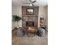 Cozy living area with a fireplace, elegant decor, and comfortable seating at 17421 E Grand Ave, Aurora, CO 80015