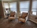 Bright living room nook featuring natural light from large windows and comfortable seating at 17421 E Grand Ave, Aurora, CO 80015